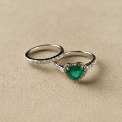 Sortija corazón de esmeralda con bordes de diamantes en oro blanco 18k.